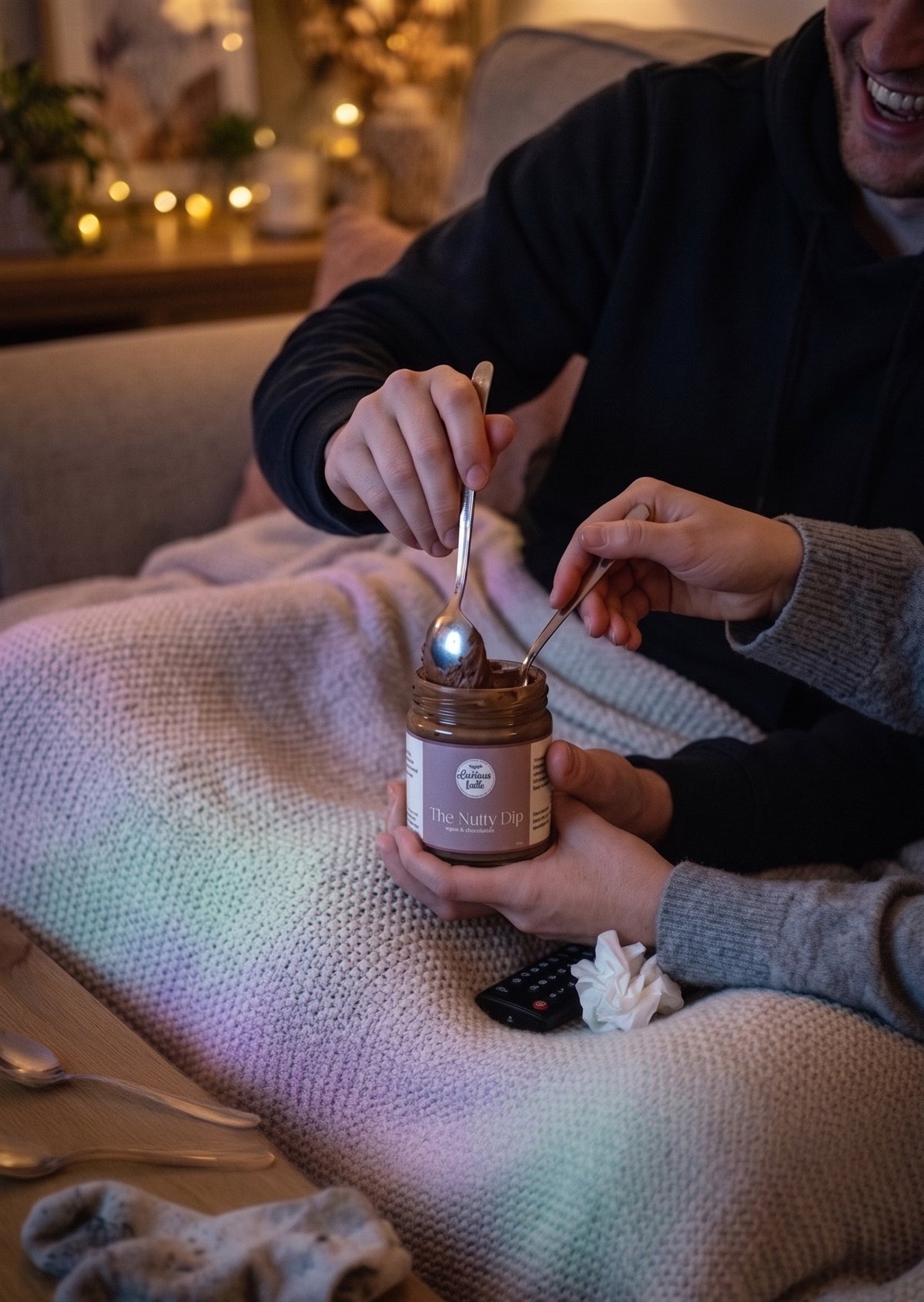 A couple sharing The Nutty Dip together on the couch